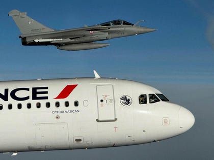 An Air France Airbus A320 aircraft, flanked by a French Armee de l'Air Rafale fighter jet en route to the Metz–Nancy–Lorraine Airport, northeastern France, on the last day of the Pope's visit to France, in September.