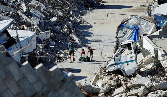 Children amid the rubble in Gaza last week. "The age of slavery has not ended. It has moved into the tents," a young Gazan woman wrote.