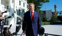 U.S. President Donald Trump talks to reporters before boarding Marine One on the South Lawn of the White House, Tuesday, in Washington.
