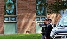 Police stand in front of the Son of Jacob Synagogue in Belleville, Ontario, which was attacked last month in the midst of Yom Kippur services.