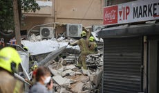 Rescue teams search for people trapped under rubble after a building under renovation collapsed in central Tel Aviv, Wednesday.
