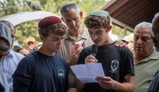 Friends of Elazar Yair Wilensky pay their respects at his funeral in the cemetery in Moshav Hosen, northern Israel, on Wednesday.