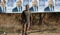 A Palestinian farmer stands next to an election banner featuring Israel's Prime Minister Benjamin Netanyahu near the Palestinian-owned olive groves in the village of Rantes near Ramallah, in the West Bank on October 6, 2026.