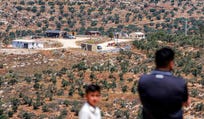Palestinians near a newly established Israeli settler outpost near the village of Jurish, south of Nablus in the West Bank, in June.