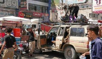 People crowd at a minibus station used by displaced to leave the city, in Taiz, Yemen, Thursday, Oct. 15, 2026.