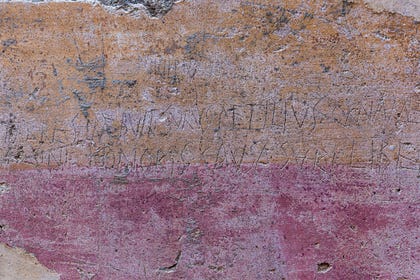 Graffiti scratched onto a two-tone plaster wall, Pompei. Credit: Aleksandra Tokarz / Shutterstock.com Graffiti scratched onto a two-tone plaster wall, Pompei