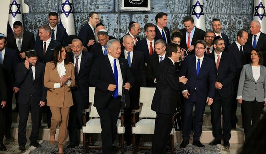 The ministers of Israel's 37th government walking away after having their photo taken, December 2022. Credit: Emil Salman The ministers of Israel's 37th government walking away after having their photo taken, December 2022.