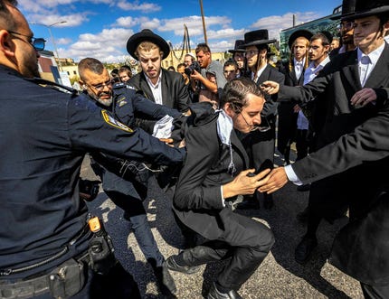 Clashes between police and Haredi demonstrators following an attempt to arrest a yeshiva student evading military service during a routine traffic stop, near the Jerusalem Cinematheque, amid protests against the conscription law, Tuesday. Credit: Olivier Fitoussi Clashes between police and Haredi demonstrators following an attempt to arrest a yeshiva student evading military service during a routine traffic stop, near the Jerusalem Cinematheque, amid protests against the conscription law, Tuesday.
