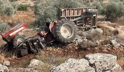 Wreckage of a tractor near the West Bank Palestinian village of Immatin after Israeli settlers pushed it down a slope, Sunday. Credit: Use under Section 27A of the Copyright Law Wreckage of a tractor near the West Bank Palestinian village of Immatin after Israeli settlers pushed it down a slope, Sunday.