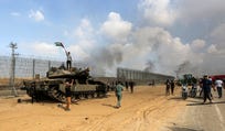 Palestinians break through the Gaza border fence, codenamed Hourglass, on October 7, 2023.