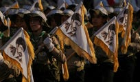 Members of Hezbollah's al-Mahdi Scouts hold flags bearing portraits of Iranian Supreme Leader Ayatollah Mojtaba Khamenei during a gathering marking the second anniversary of the assassinations of Hezbollah leaders Hassan Nasrallah and his cousin and successor, Hashem Safieddine, who were killed in Israeli airstrikes, in Dahiyeh, a southern suburb of Beirut, Lebanon, earlier this month.