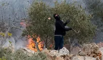 An Israeli settler hurling stones near Ramallah, earlier this month.