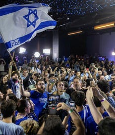 Democrats supporters celebrate at the party's headquarters on Tuesday following the release of exit polls. Credit: Hadas Parush Democrats supporters celebrate at the party's headquarters on Tuesday following the release of exit polls.